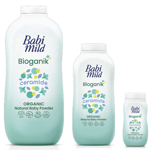 Three different sizes of Babi Mild Bioganik Baby Powder bottles arranged side by side against a white background.