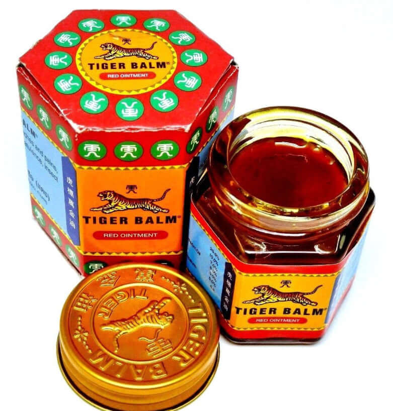 Tiger Balm Red ointment jar and packaging, extra-strength herbal pain relief balm for muscle and headache relief.