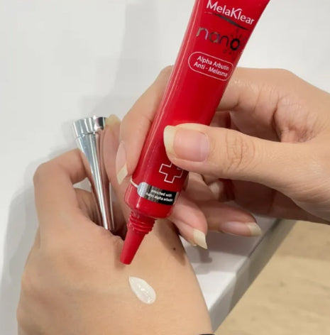 Applying Melaklear Nano Alpha Arbutin Cream on skin to reduce dark spots and freckles.