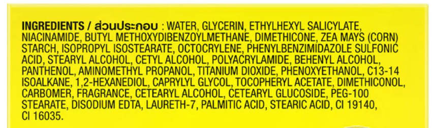 Close up of the ingredient list and warning label on Olay Natural Aura Cream yellow packaging