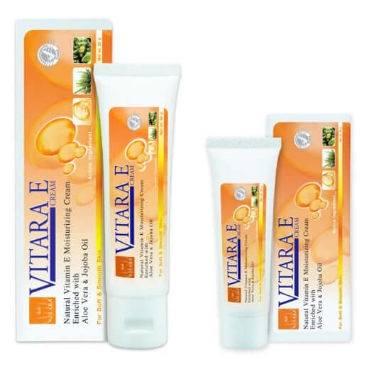 Two tubes 25,50ml and packaging boxes of Vitara E Moisturizing Cream with natural vitamin E, aloe vera, and jojoba oil.