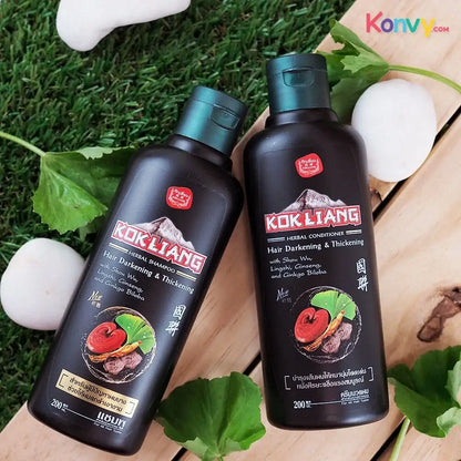 Kok Liang Hair Darkening Chinese Herbal Shampoo and Conditioner set on green grass background, rejuvenates hair for vibrant look.
