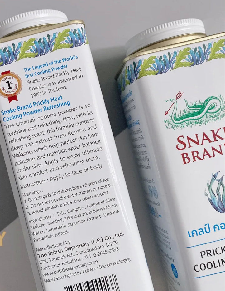 Snake Brand Prickly Heat Cooling Powder Kelp Complex tin showing product labels and ingredients on the side.