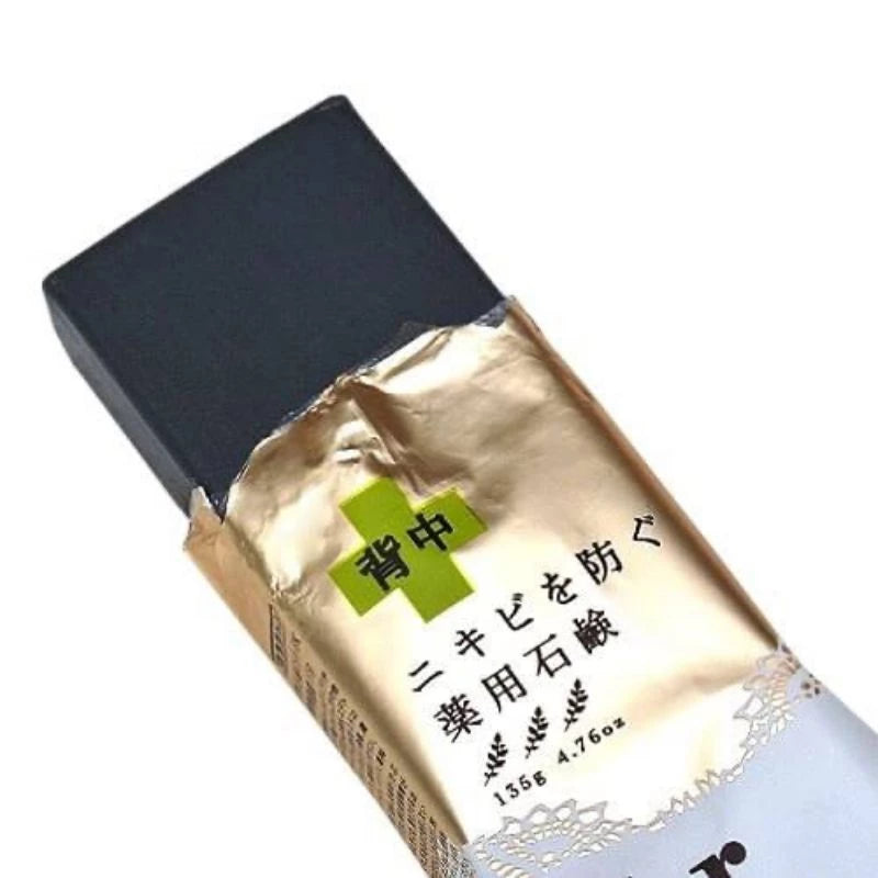 Pelican For Back Acne Soap charcoal bar close-up with herbal ingredient accent.