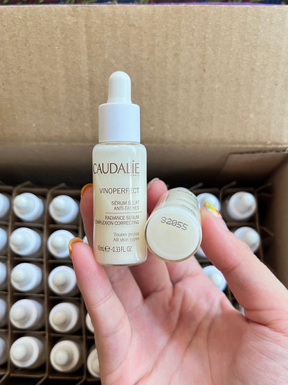 Caudalie Vinoperfect Serum 10ml travel size placed inside gift box with multiple mini bottles