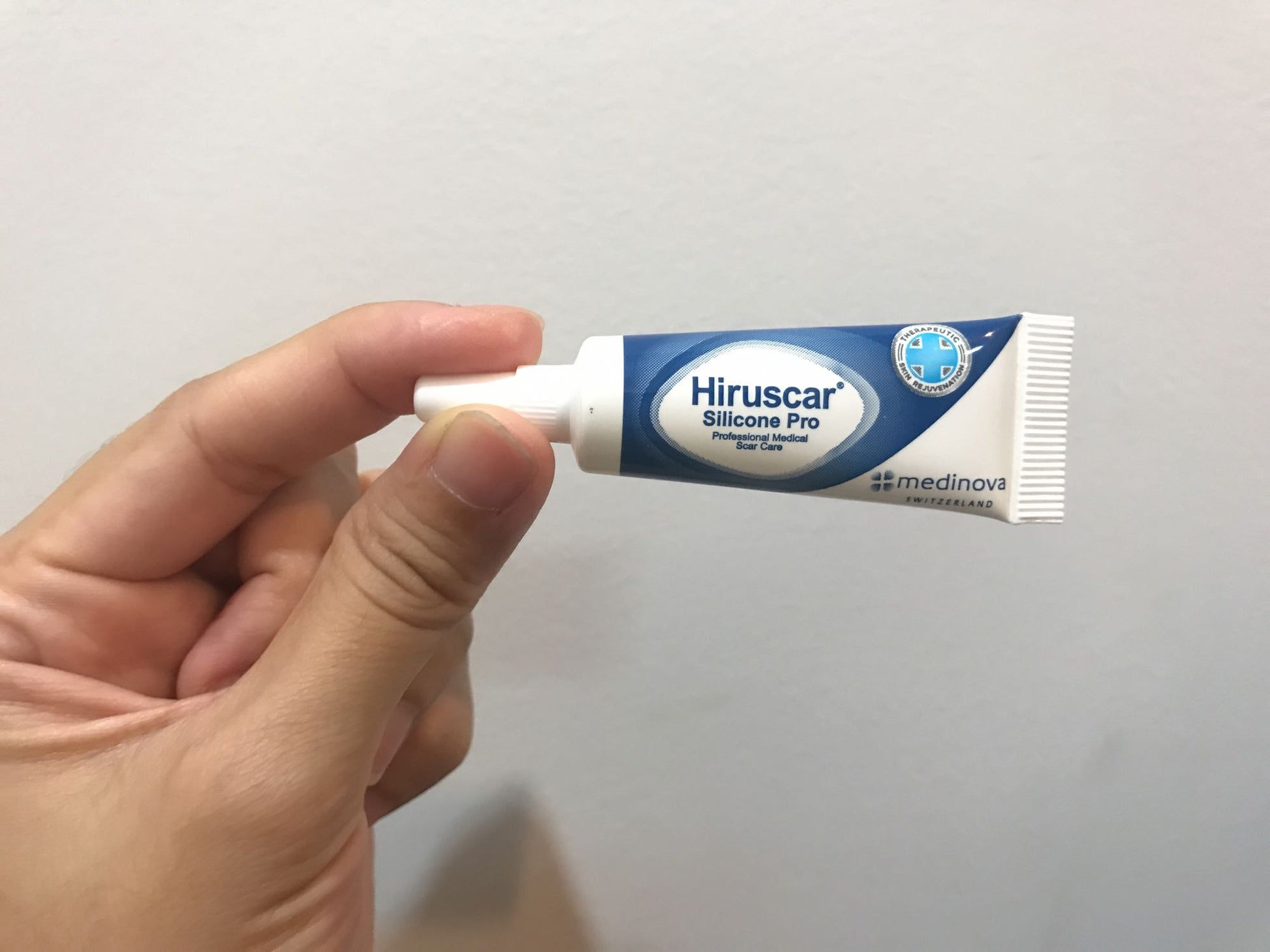 Hiruscar Silicone Pro Gel 4g tube held in hand showing compact scar care packaging