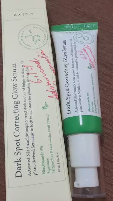 AXIS-Y Dark Spot Correcting Glow Serum packaging with description, featuring niacinamide for radiant skin tone.