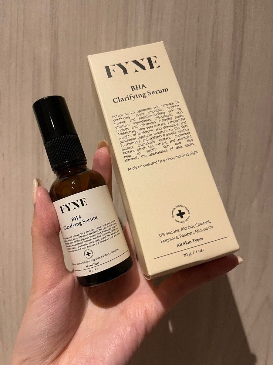 FYNE BHA Clarifying Serum bottle shown together with its packaging box in a hand for product presentation