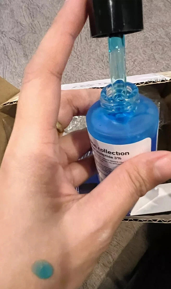 The Skin Collection Serum dropper application on skin blue serum texture