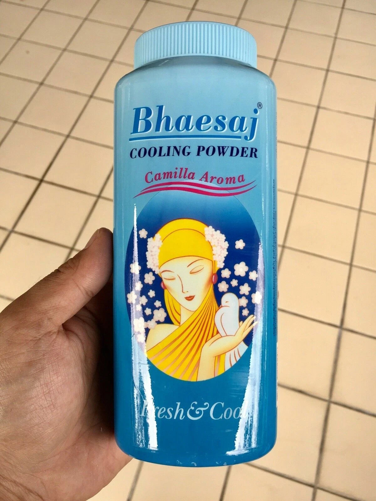 Bhaesaj Cooling Powder Camellia Aroma bottle held in hand showing size and design