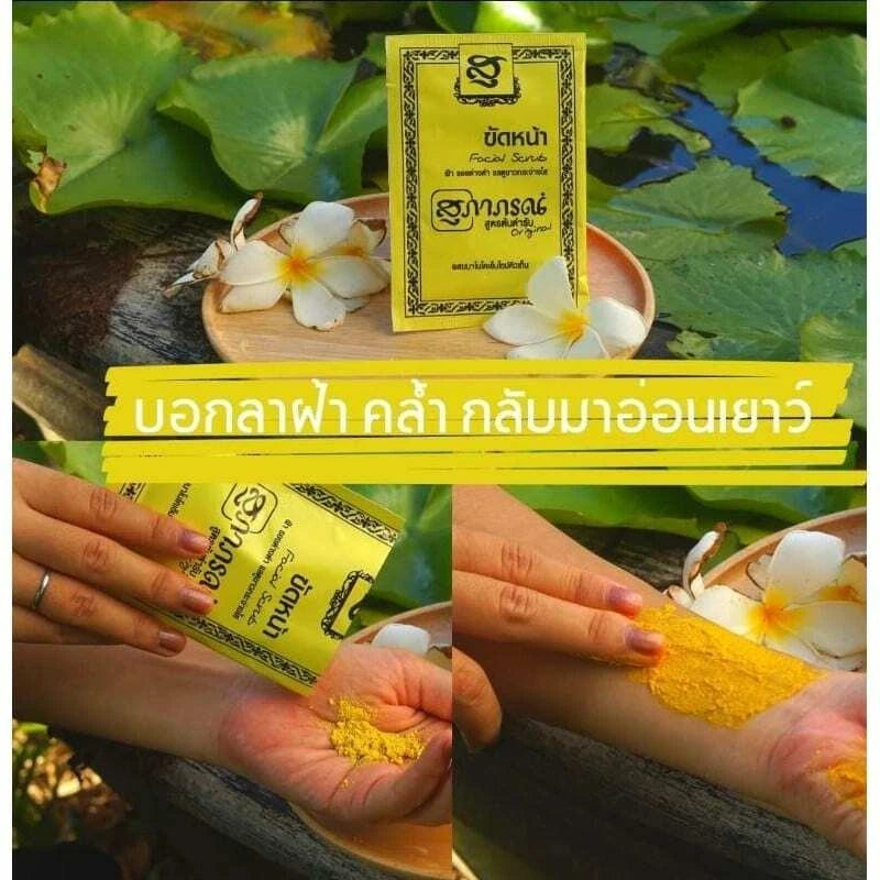 Supaporn Facial Scrub sachet displayed on a pile of yellow Thai herbal ingredients and turmeric roots.