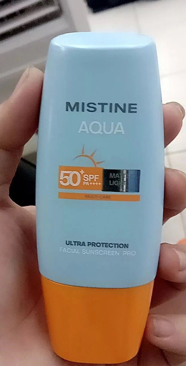 Mistine Aqua Sunscreen SPF50 PA++++ bottle held in hand close up product view