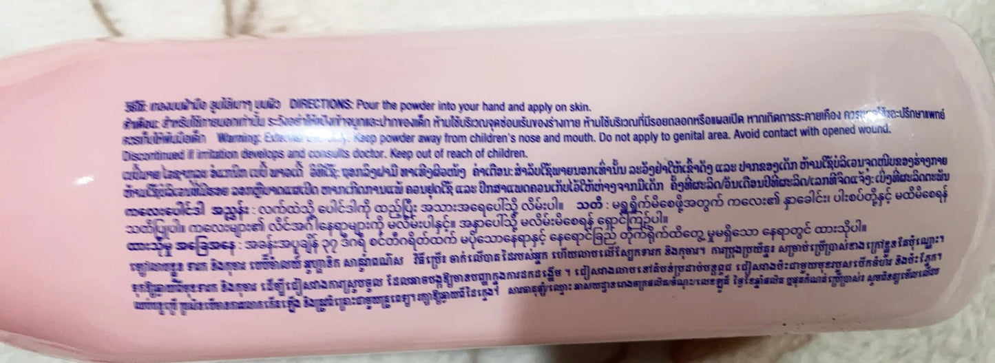 Babi Mild White Sakura Baby Powder label with directions and ingredients for gentle organic baby care.