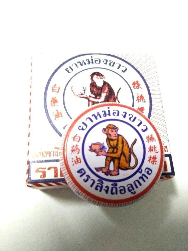 Thai Golden Cup Monkey Holding Peach White Balm set packaging featuring herbal pain relief ointment.