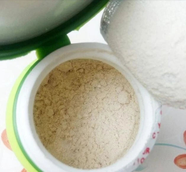 Supaporn Tooth Powder inside a container, showcasing the fine, herbal polishing powder for healthy teeth.