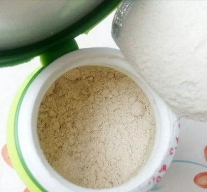 Supaporn Tooth Powder inside a container, showcasing the fine, herbal polishing powder for healthy teeth.