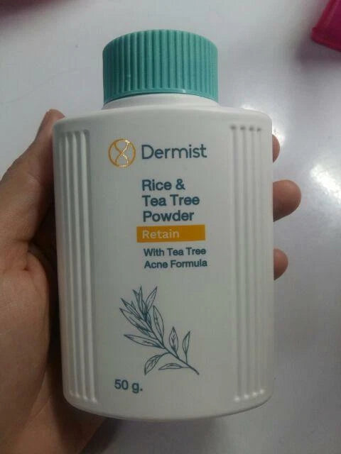 Dermist Rice Tea Tree Powder single bottle close-up hand holding