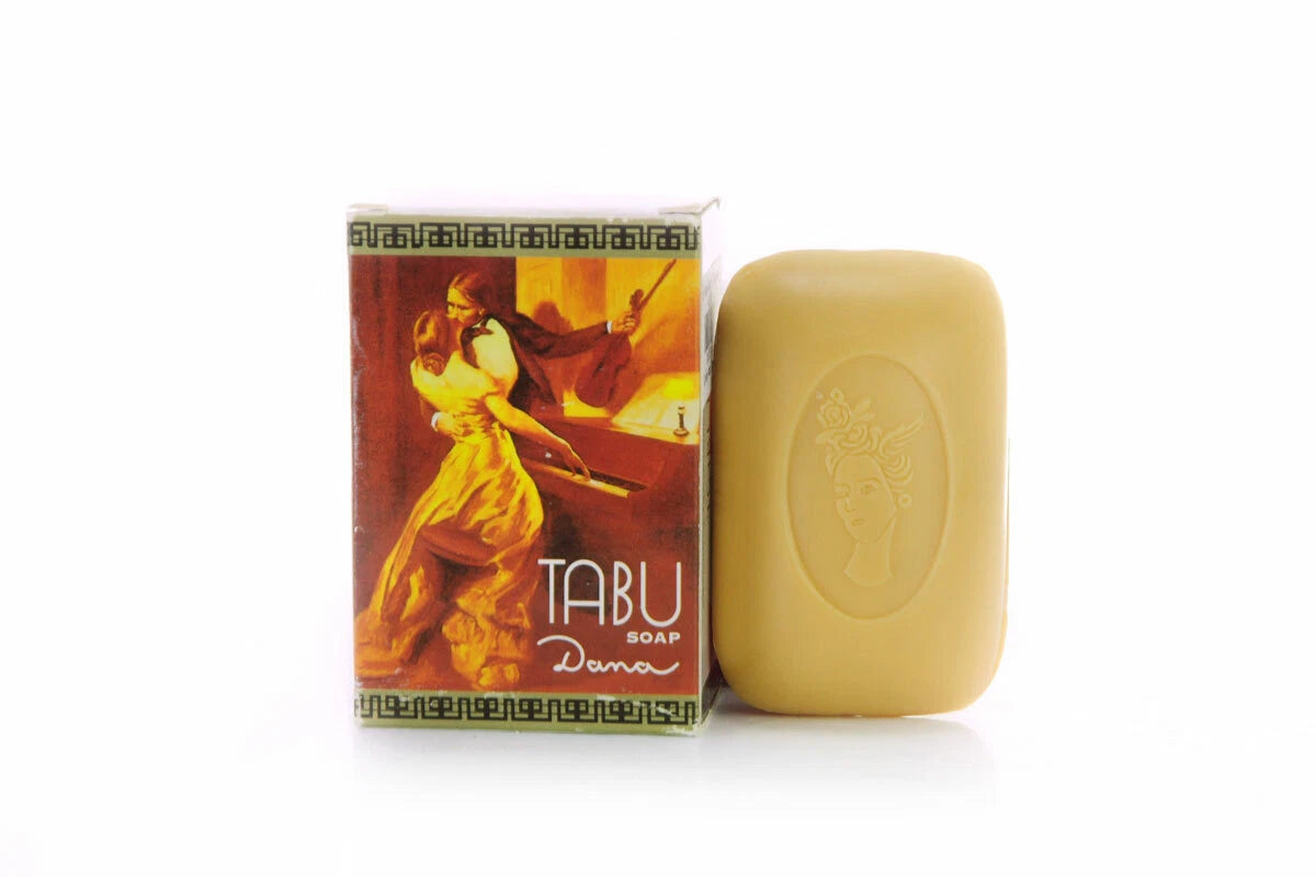 Tabu Dana Soap Bar removed from the box, showing the light yellow soap color next to the packaging.