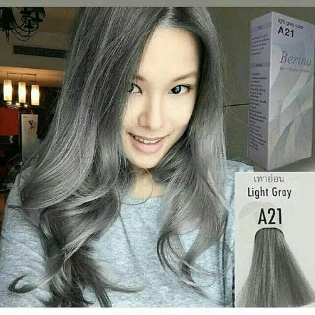 Model with light grey hair using Berina A21 Light Grey Permanent Hair Dye with product box visible