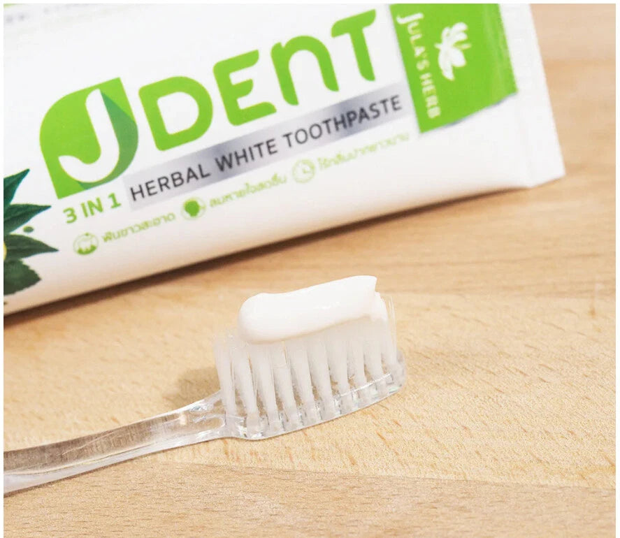 Jula Herb JDent Toothpaste with toothbrush showing paste texture close up