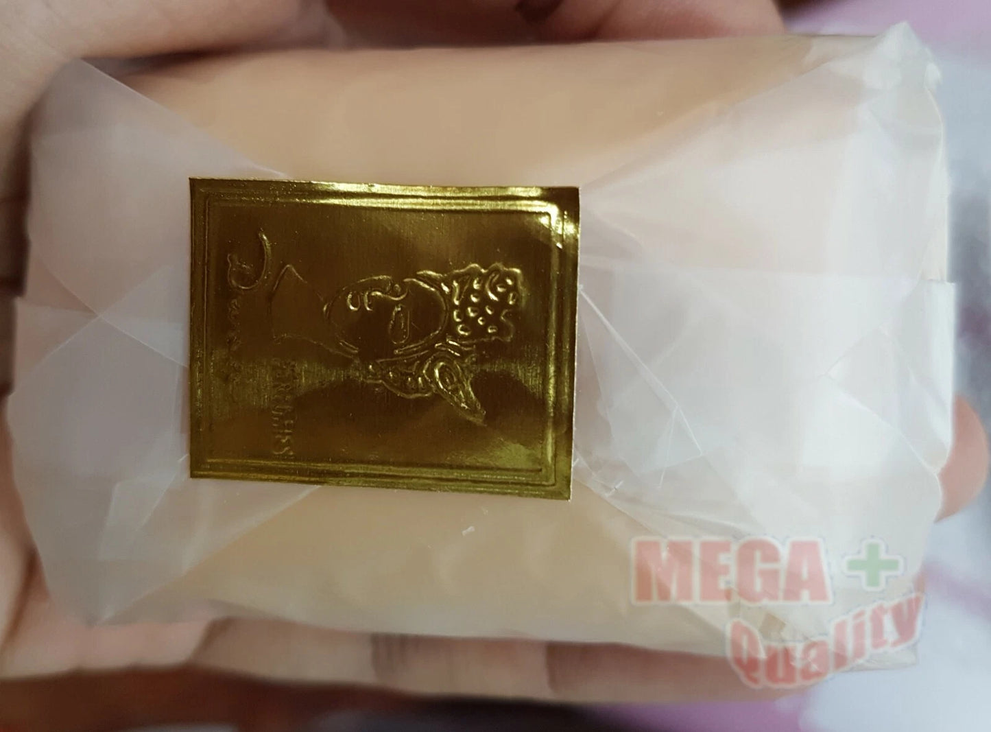 Close up of the Tabu Dana Soap Bar itself, wrapped in clear plastic with a small gold label.