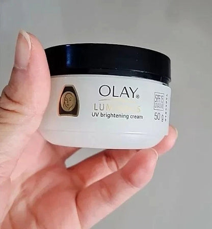 Olay Luminous Cream jar held in hand product close up