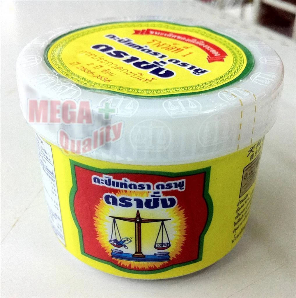 A shot of the Trachang brand shrimp paste jar from a low angle, highlighting its transparent plastic packaging and yellow label.
