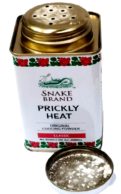 Opened Snake Brand Prickly Heat Classic Cooling Powder tin showing powder inside.