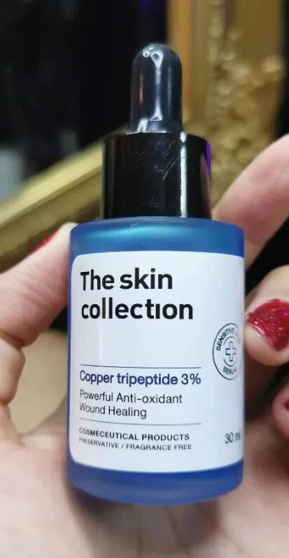 The Skin Collection Serum copper tripeptide 30ml bottle held in hand
