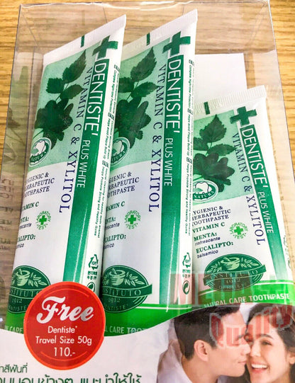 Three herbal toothpaste tubes with green leaves design on wooden background