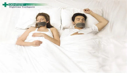  A couple in bed holding Dentiste Plus White Toothpaste, highlighting nighttime use