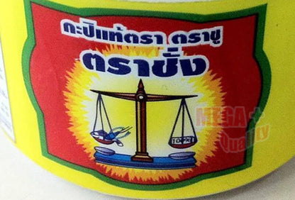 A close-up of the Trachang brand shrimp paste label, focusing on the Thai text and the scale logo.