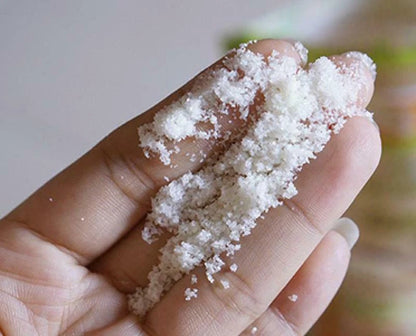 A Bonne Spa Milk Salt scrub applied on hand with salt crystals