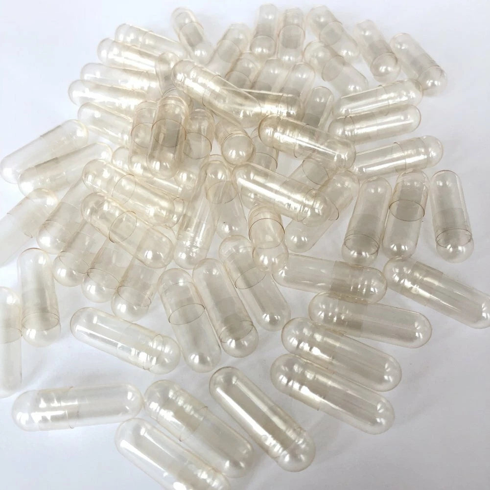  Clear Empty Vegetarian Capsules Size 0 scattered on white background