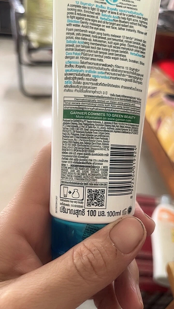 Garnier Pure Active face wash held in hand bottle view