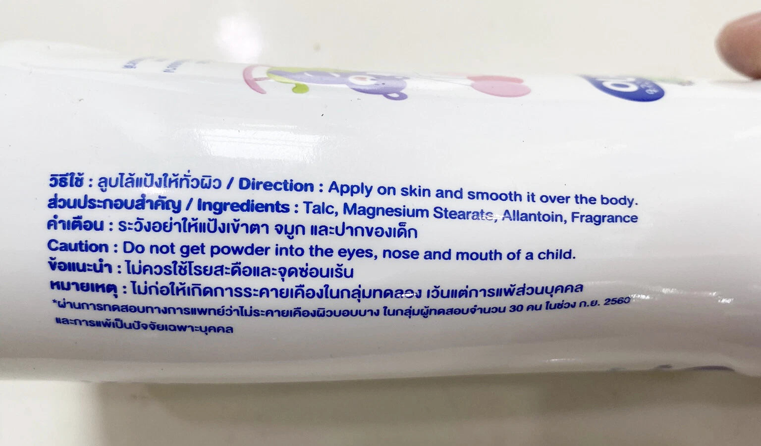 Close-up of Kodomo Baby Powder Extra Mild label showing ingredients and natural extract details