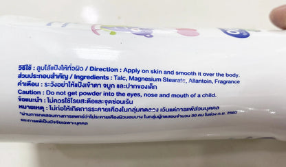 Close-up of Kodomo Baby Powder Extra Mild label showing ingredients and natural extract details
