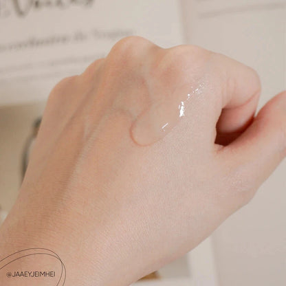 Texture of FYNE BHA Clarifying Serum applied on the back of a hand showing lightweight, smooth consistency