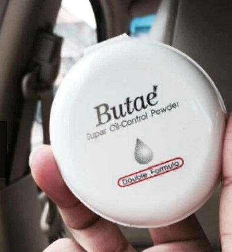 Butae Super Oil Control Powder handheld compact showing logo