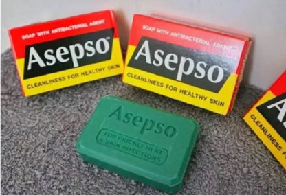 Asepo green soap bar on a gray surface with its box in the background.