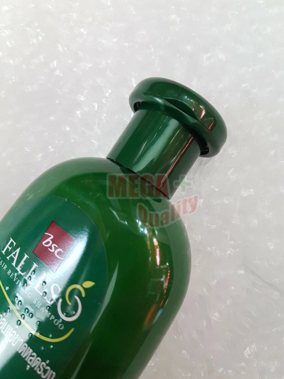 Tilted angle of Falles Kaffir Lime Hair Reviving Shampoo 300 ml green bottle with product label.