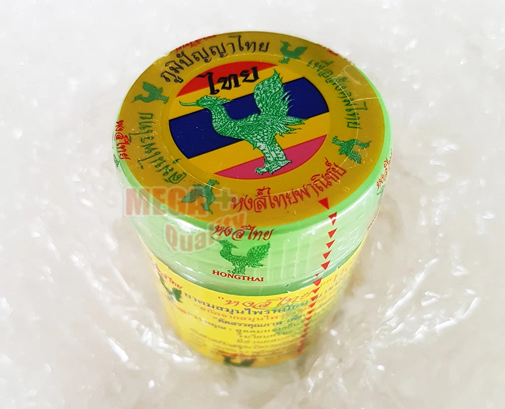 Top view of Hong Thai Herbal Balm jar showing the gold lid with brand logo and Thai flag design.