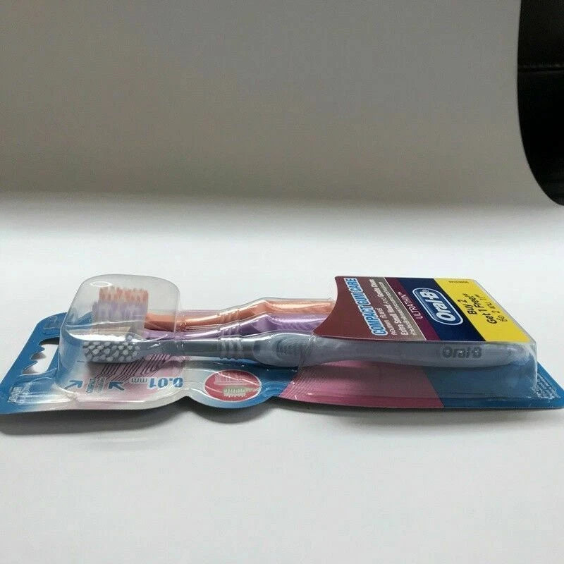 Flat lay of Oral B Compact Gum Care extra soft toothbrush pack showing compact head size