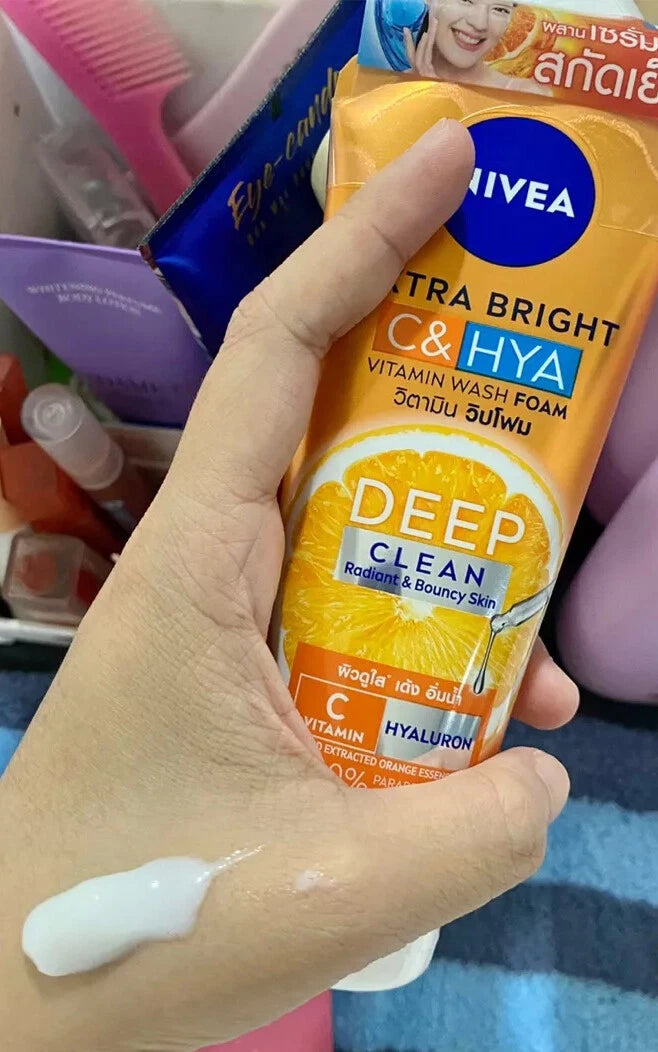 Nivea Extra Bright C Hya Foam cleanser tube held in hand lifestyle image