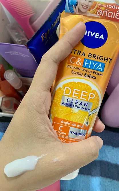 Nivea Extra Bright C Hya Foam cleanser tube held in hand lifestyle image