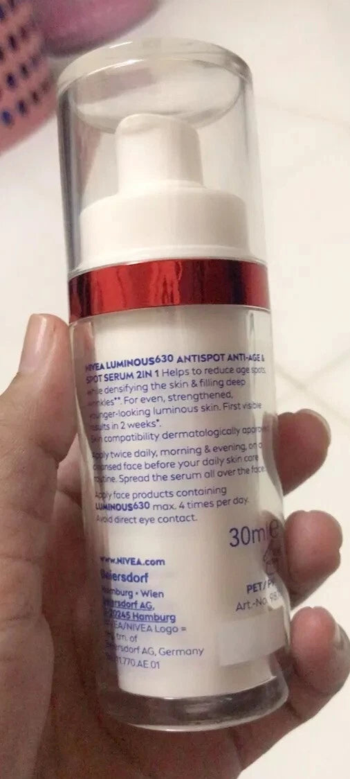 Nivea Luminous 630 Spot Serum facial care bottle held in hand