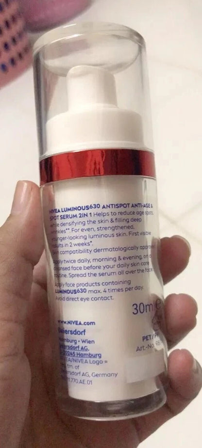 Nivea Luminous 630 Spot Serum facial care bottle held in hand