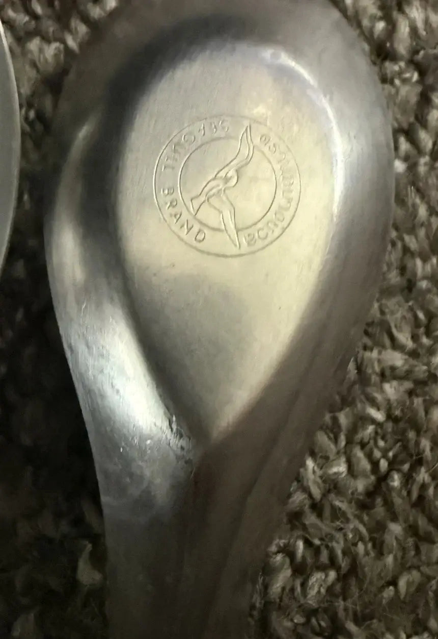 Seagull Stainless Chinese Spoon logo embossed on the surface of a small stainless steel spoon.