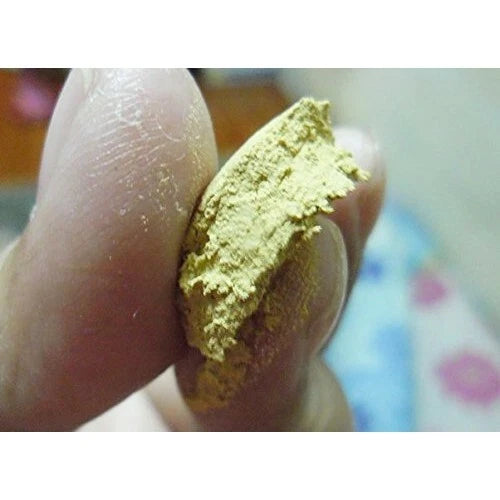 Close-up of Thanaka Powder pressed into a solid disk showing texture and color