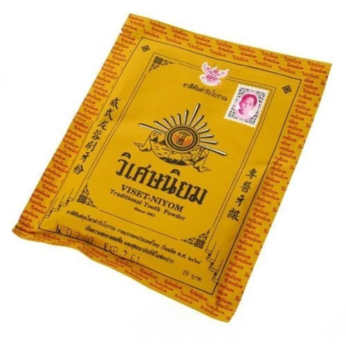 Front pouch of Viset Niyom Tooth Powder traditional Thai herbal tooth powder in yellow packaging